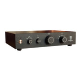 Front three-quarter view of the STRAUSS ELEKTROAKUSTIK SE PRE-1S Reference Analog Preamplifier on a white background, highlighting the tactile rotary volume control, input selector knob, physical EQ tilt and direct mode toggle switches, and precision minimal chassis layout.