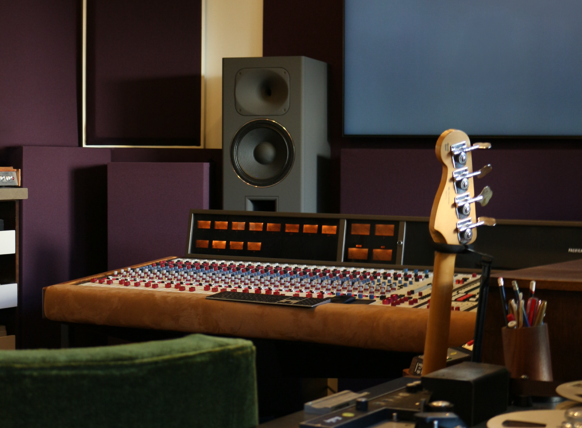 Interior view of the STRAUSS ELEKTROAKUSTIK USA flagship showroom in Los Angeles, highlighting a massive MF-4 main monitoring speaker positioned behind a custom vintage 1978 Quad Eight Pacifica mixing console, set within a precision-engineered critical listening environment with dark acoustic wall paneling.