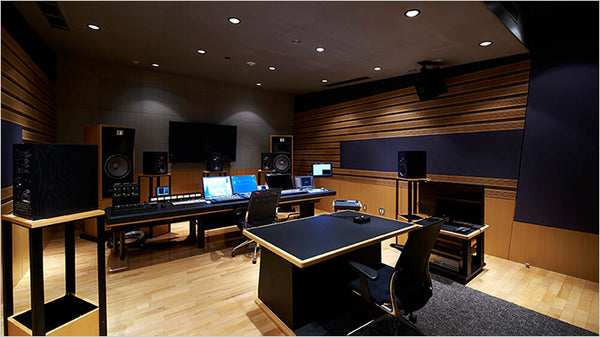 Wide interior view of a world-class mastering suite at Sony Music Studios Tokyo, showcasing the custom flush-mounted main monitoring walls featuring integrated STRAUSS ELEKTROAKUSTIK SE-MF-2.0 mastering studio monitors, paired with an elegant analog console and precision outboard gear under warm studio lighting.